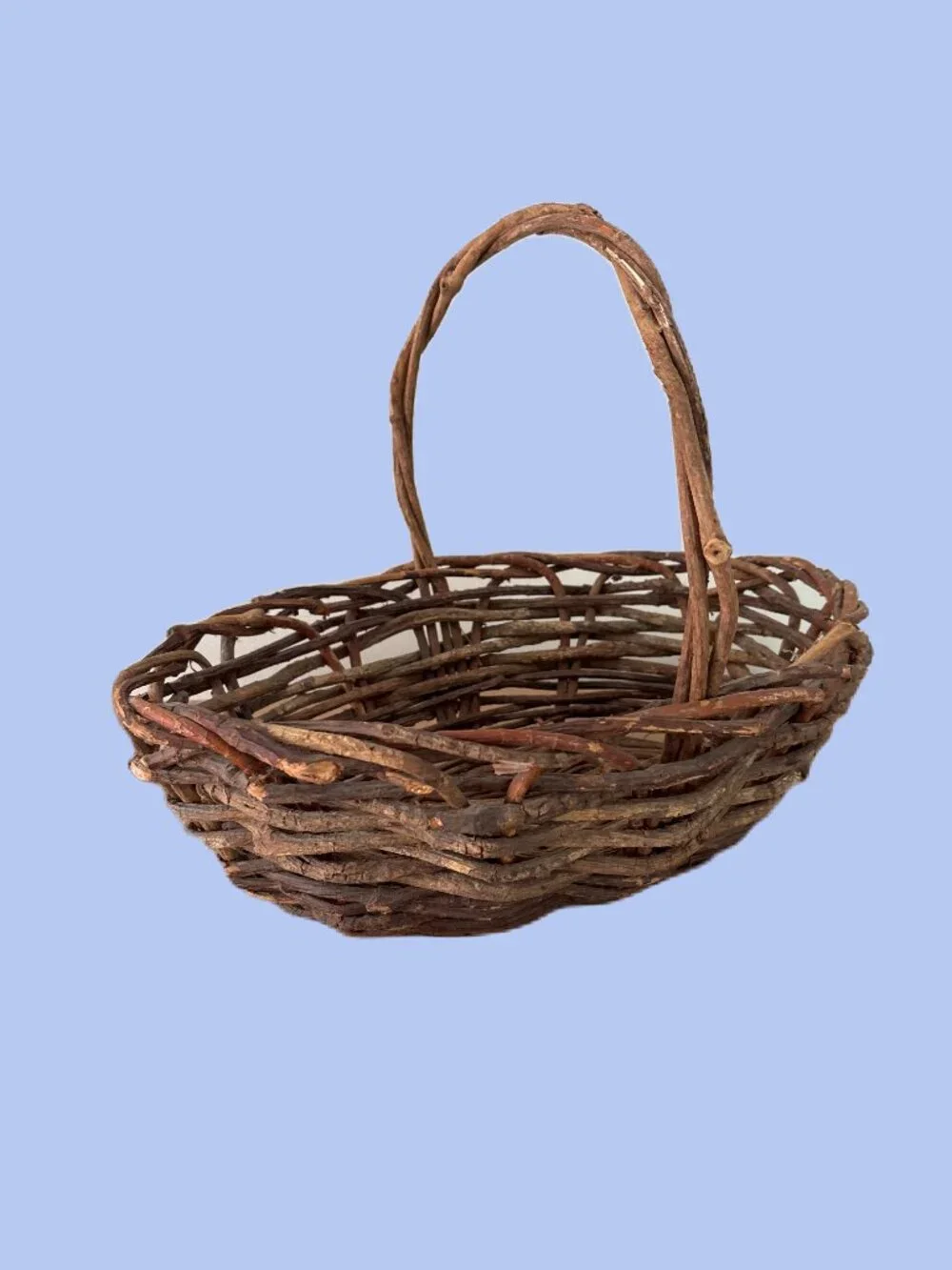 Handwoven vintage twig gathering basket with handle.
